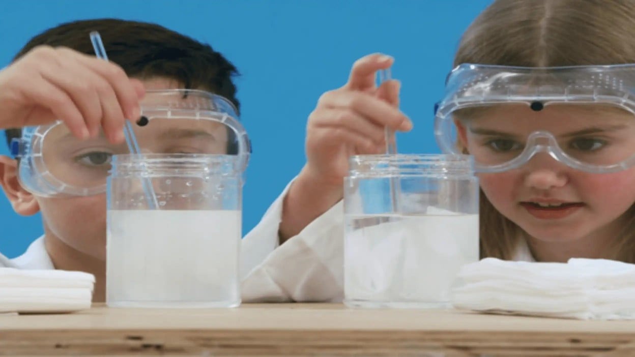 Des enfants en blouse de laboratoire et lunettes de protection